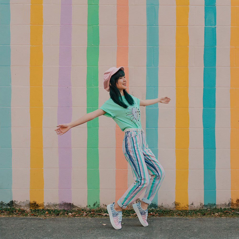 Girl standing on toes, wearing pastel ombre Roxy Sheilahh casual shoes.