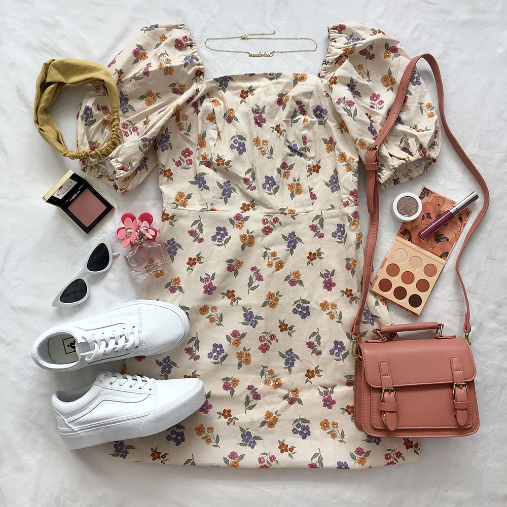 Flatlay featuring Vans Old Skool platform shoes in white monochrome, featuring a floral patterned dress and warm toned accessories